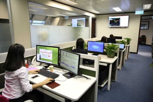 An office with administrativee assistants at their desks
