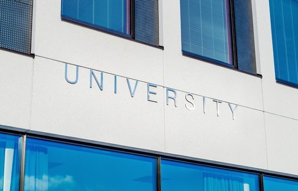 Wall with large windows and the sign "University".